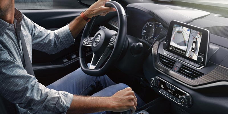 Driver's view of a Nissan car interior, showing the steering wheel