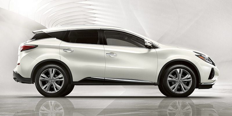 Side view of a white Nissan Murano SUV on a glossy floor