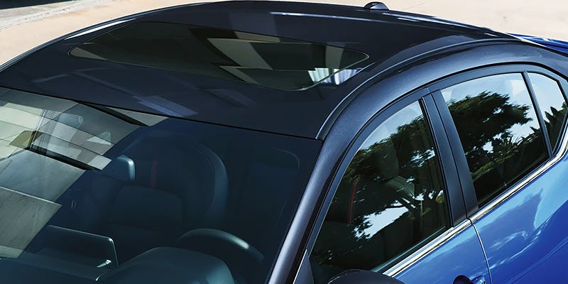 Aerial view of a blue car, showing the tinted sunroof,