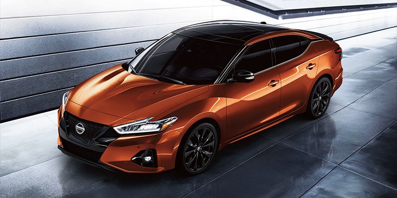 A perspective shot of an orange Nissan Maxima