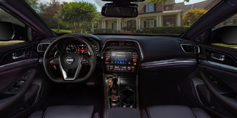 Driver's view of a car interior with a black dashboard and steering wheel