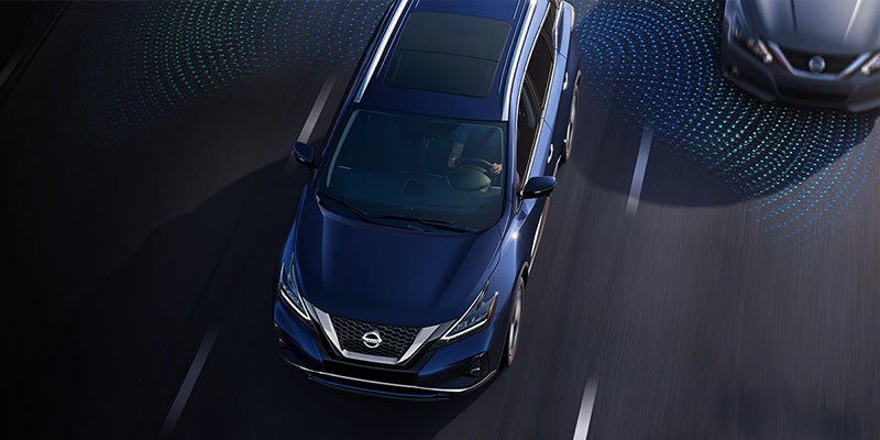 Overhead shot of a blue SUV with a smart sensing system, shown