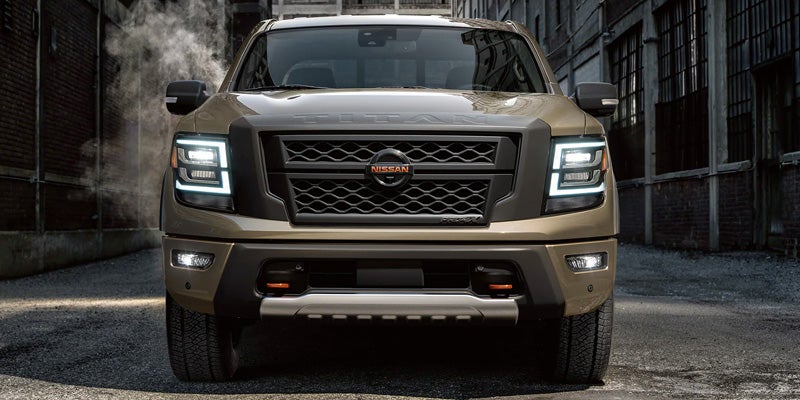 Front view of a gold Nissan Titan pick up truck