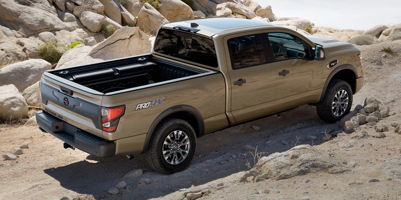 Tan Nissan Titan PRO-4X pickup truck from behind