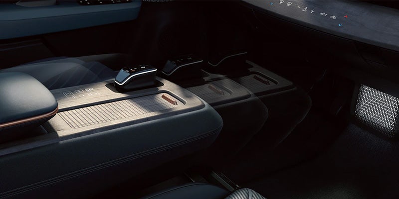 Close-up of a modern car's dark interior, featuring a sleek center console